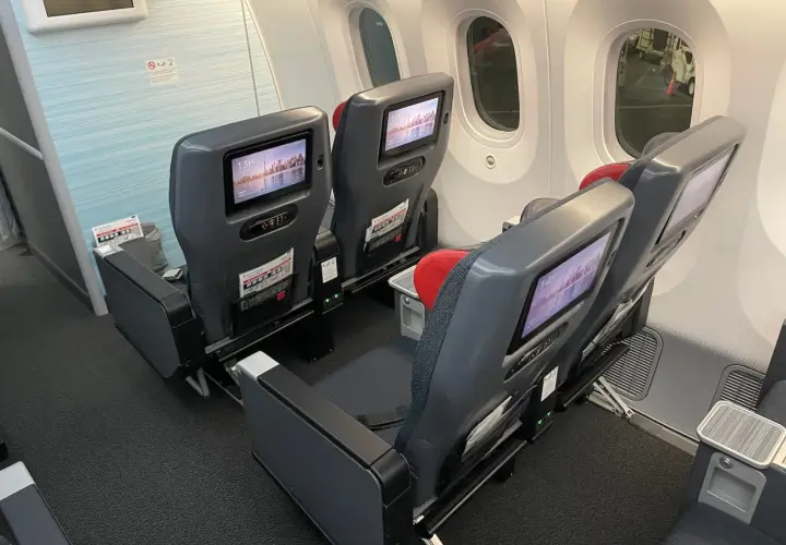 Dreamliner lot klasa ekonomiczna. Siedzenia w samolocie z ekranami rozrywki pokładowej, gotowe na podróż.