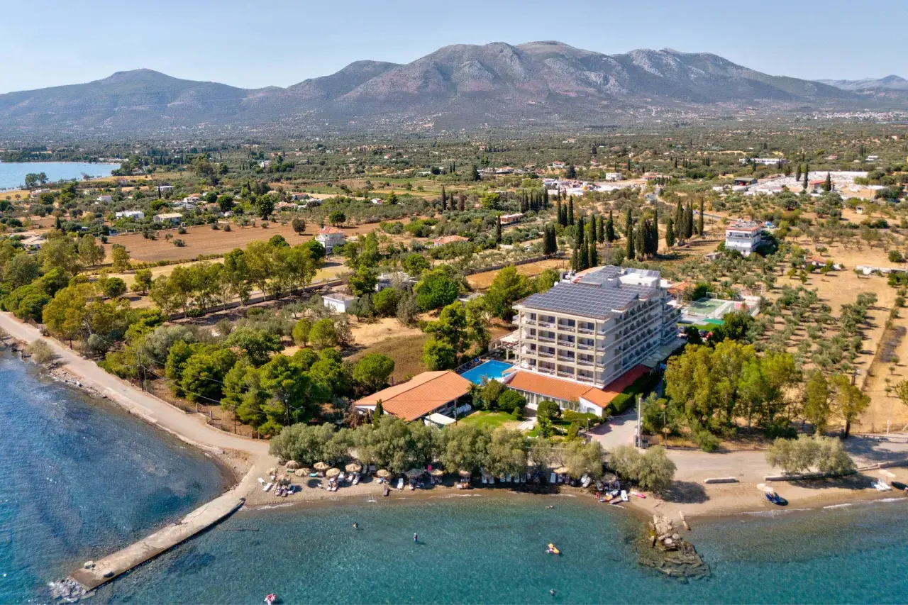 Hotel z panelami słonecznymi nad morzem, z plażą i górami w tle. Wakacje na wyspie Evia.