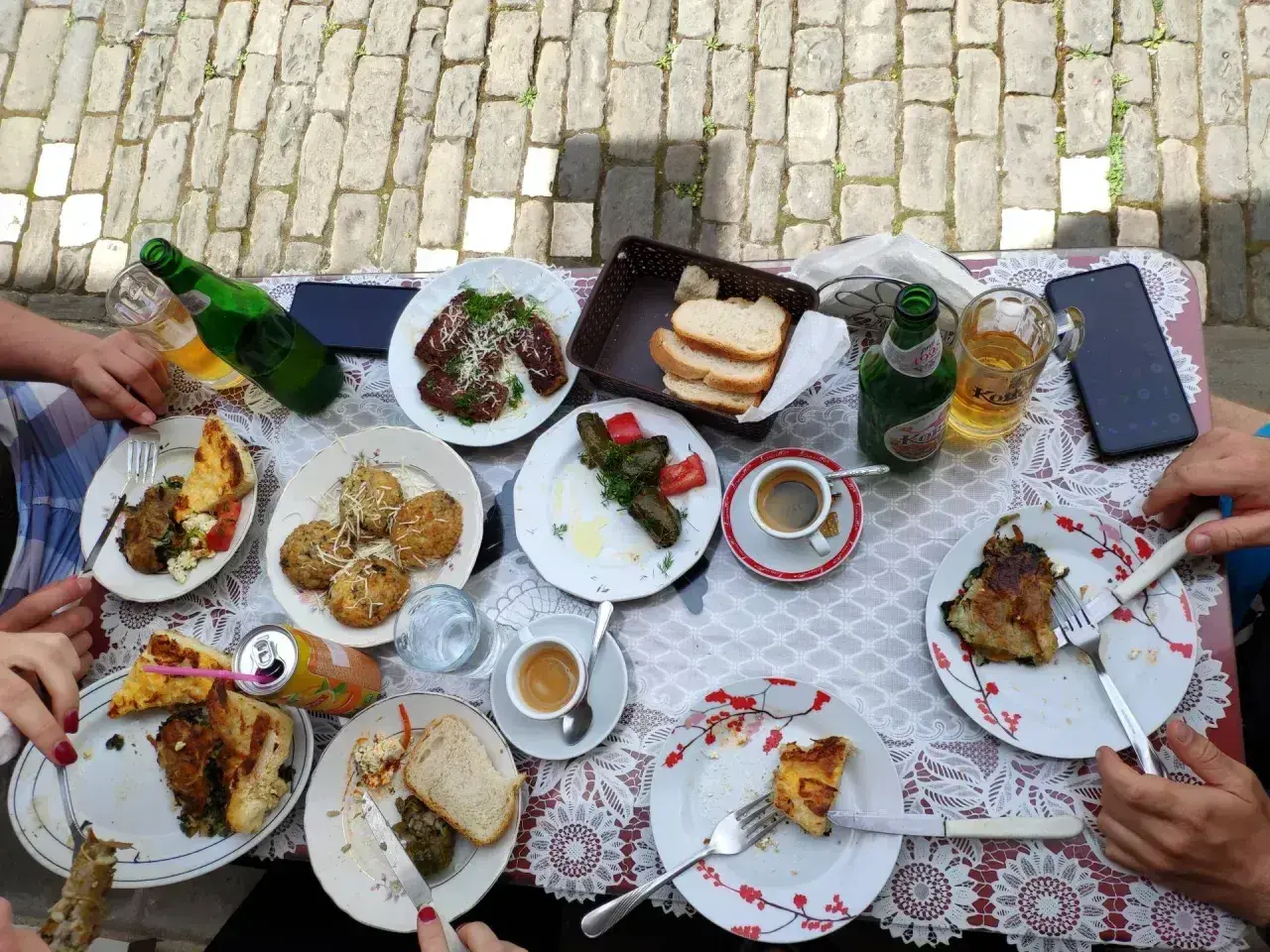 Pyszne albania jedzenie na stole: mięso, pieczywo, kawa i piwo.